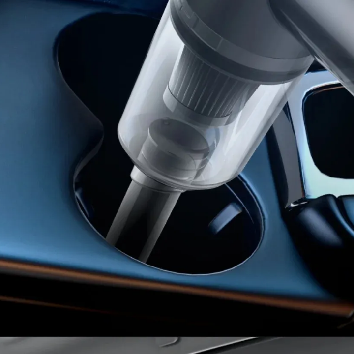 Car cup holder with a handheld vacuum cleaner inside