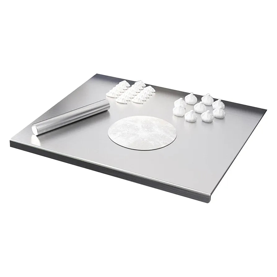 Metallic tray with a round component and small white objects on a white background