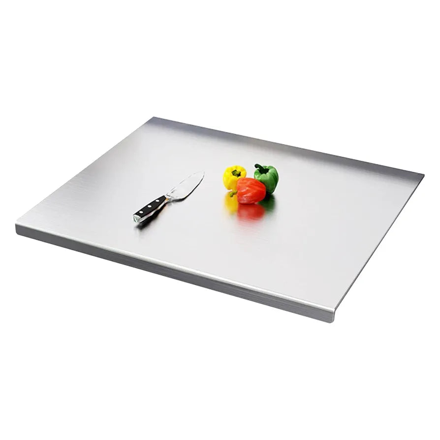Stainless steel cutting board with a knife and colorful peppers on a white background