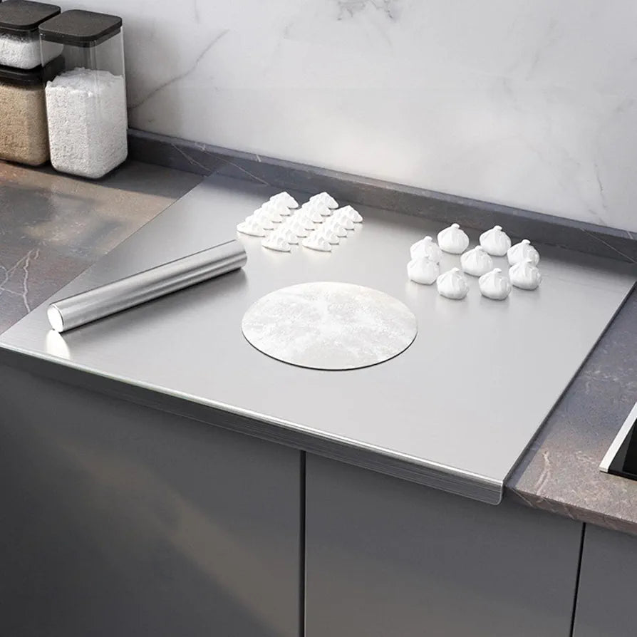 Roll of paper towels on a kitchen counter with a marble backsplash.